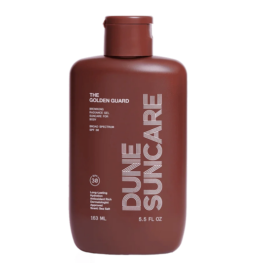 A brown bottle of Dune Suncare The Golden Guard sunscreen gel with white and silver text detailing the product name and benefits.