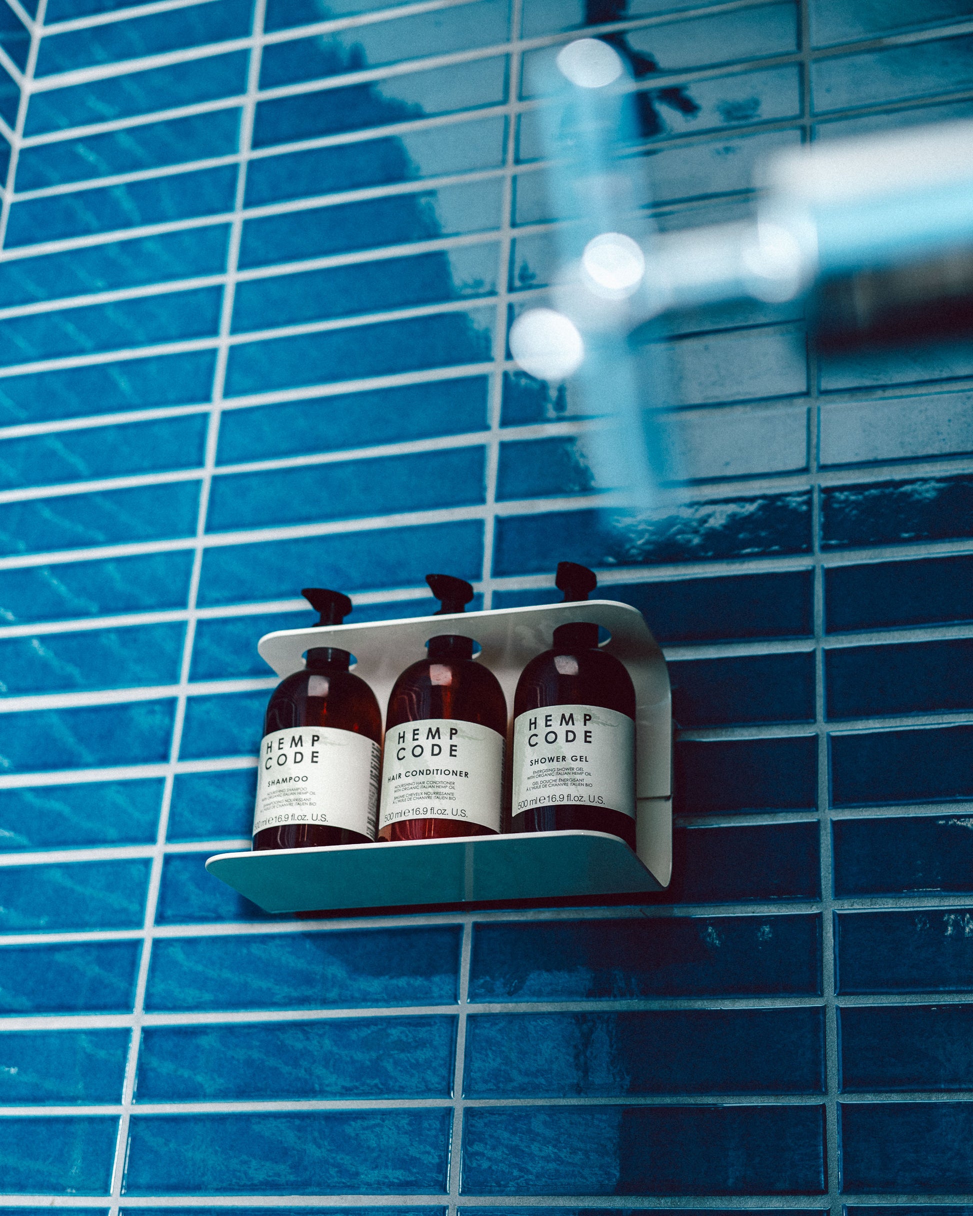 Photograph of hemp code products in hanging shelf with blue tile wall