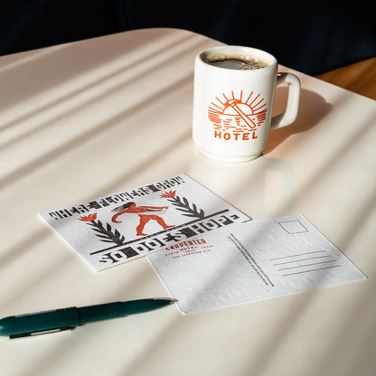 A postcard with letterpress text and illustration, featuring a figure sowing seeds among flowers, with the text 'WHERE FLOWERS GROW SO DOES HOPE - LADY BIRD' pictured with a pen and mug of coffee on top of beige table.