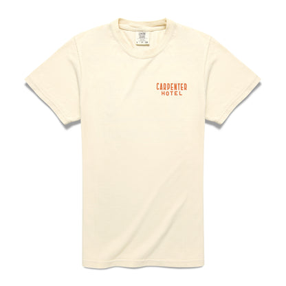 A beige Carpenter Hotel Tee with short sleeves and the logo 'CARPENTER HOTEL' printed on left side of the chest.
